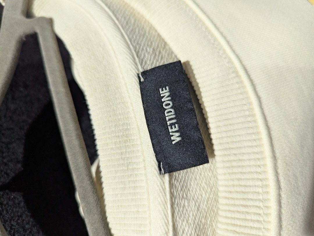 We11done Multi Logo Long Sleeve Sweatshirt Off-White Size M (Category: Coats, Jackets and Outerwear) located in Manila. Submitted by grandwater.53a8ce (Listing ID 1465489415, Image 2). Description: - Brand: We11done - Color: Cream / Off-white - Size: Medium (M) - Material: 100% Cotton shell - Design: Colorful stacked typography prints on the front, with ribbed collar, cuffs, and hem - Authenticity: Includes Certilogo tag.