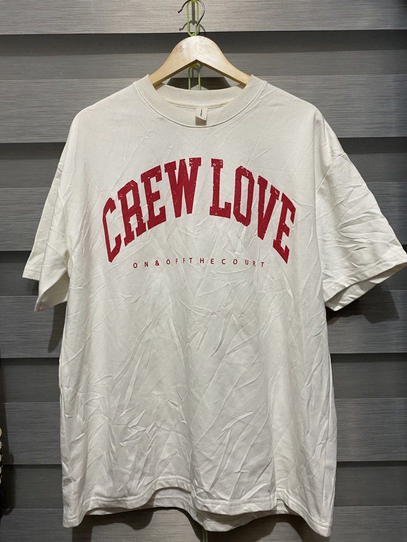White Crew Love Graphic T-Shirt (Category: Shirts) located in Butuan. Submitted by nielben13 (Listing ID 1465392986, Image 1). Description: - Color: Crisp white with red distressed print - Design: 'CREW LOVE ON & OFF THE COURT' bold graphic - Fit: Relaxed, comfortable streetwear style - Details: Classic ribbed collar, standard sizing label.