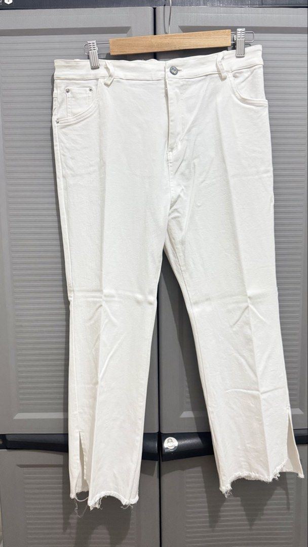 White denim pants with raw hem and side slits (Category: Jeans) located in Quezon City. Submitted by heyhaveaniceday (Listing ID 1465496119, Image 1). Description: - Style: Straight cut, ankle length with trendy side slits at the bottom hems - Detailing: Raw frayed hems and distressed top edges on the back patch pockets - Design: Classic standard five-pocket setup with a front button and zip closure - Color: Solid crisp white - Condition: Brand n