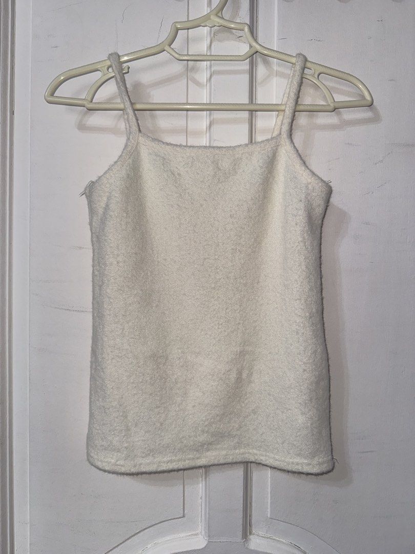 White fuzzy knit cami tank top (Category: Sleeveless) located in Santa Ana. Submitted by fatikilla (Listing ID 1465391445, Image 1). Description: - Color: White - Material: Soft, fuzzy knit fabric - Design: Square neckline with thin spaghetti straps - Versatile: Great for layering or wearing solo - Easy to style: Pairs perfectly with denim or skirts.