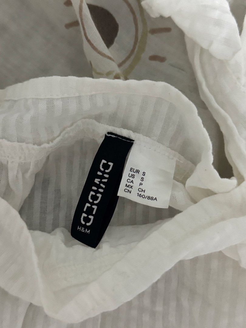 H&M White Summer Seersucker Ruffle Strap Cami Top (Category: Others Tops) located in Manila. Submitted by glossywife (Listing ID 1465475709, Image 2). Description: Size small Perf for summer! Bnew w no tags Never been tried on or worn out Rfs: Decluttering Mop: GCash / Bank Transfer Mod: GrabExpress / J&T / Lalamove Brandy Melville Zara Isa the label H&M Cotton On Stradivarius Phia Hollister Subdued John Galt Miu the label Traje Linen Bershka Ari