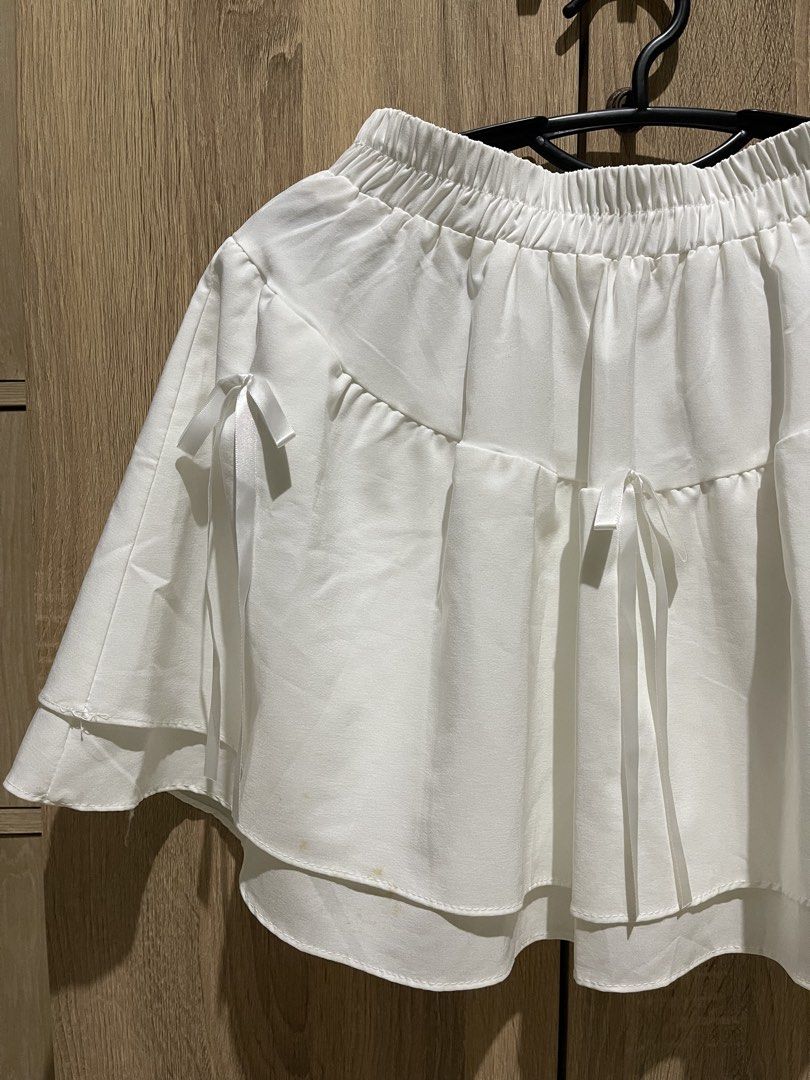White tiered mini skirt with ribbon bows (Category: Skirts) located in Manila. Submitted by preloveditems_jem (Listing ID 1465475113, Image 2). Description: Super cute white mini skirt with double-layered ruffles, playful ribbon bows, and a comfy elastic waistband. Made of light, soft fabric and very stretchy. Please note there are minor yellowish stains near the bottom hem!.