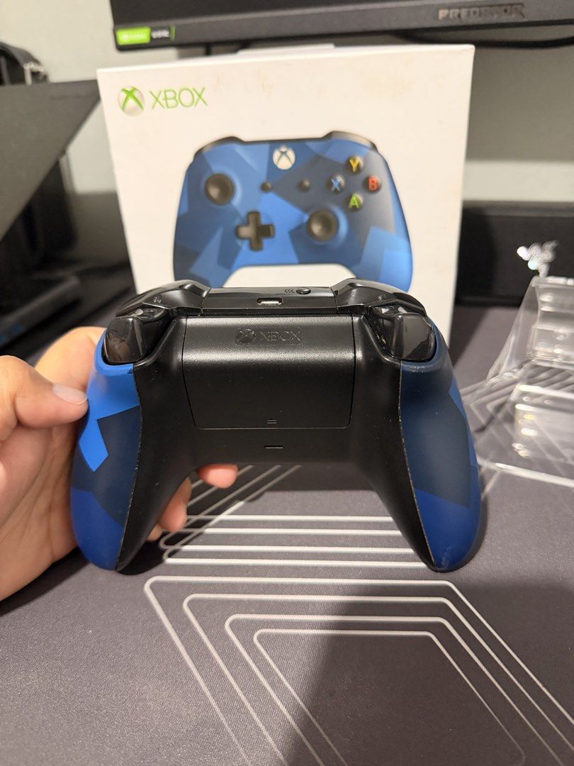 Xbox Wireless Controller Midnight Forces II Edition (Category: Controllers) located in Cainta. Submitted by kenarceno (Listing ID 1465446037, Image 2). Description: - Model: Xbox Wireless Controller (Midnight Forces II Blue Camo) - Condition: Clean outer shell, all buttons fully responsive - Included: Original box and FREE clear display stand - Features: Standard layout (dual analog sticks, D-pad, ABXY), Micro-USB port, and 3.5mm headphone jack -