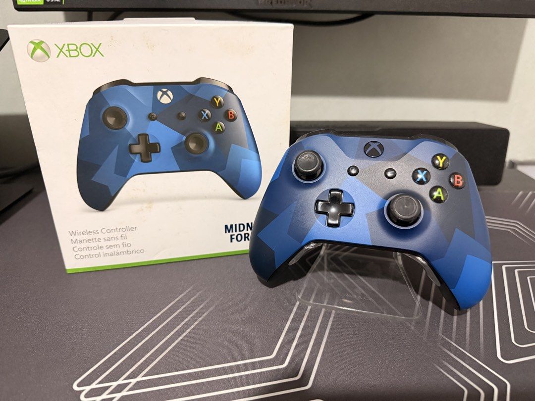 Xbox Wireless Controller Midnight Forces II Edition (Category: Controllers) located in Cainta. Submitted by kenarceno (Listing ID 1465446037, Image 1). Description: - Model: Xbox Wireless Controller (Midnight Forces II Blue Camo) - Condition: Clean outer shell, all buttons fully responsive - Included: Original box and FREE clear display stand - Features: Standard layout (dual analog sticks, D-pad, ABXY), Micro-USB port, and 3.5mm headphone jack -