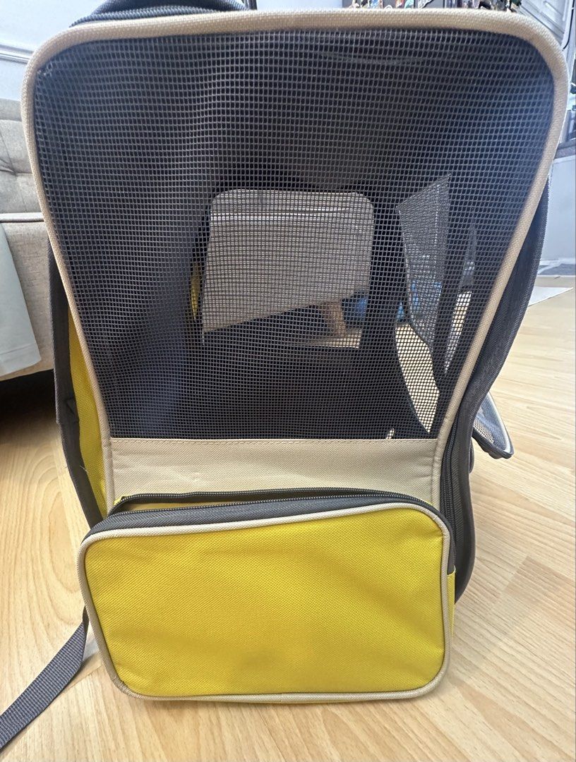 Yellow and beige pet carrier backpack (Category: Homes & Other Pet Accessories) located in Mandaluyong City. Submitted by mathizer3086 (Listing ID 1465397604, Image 3). Description: Yellow and beige pet carrier backpack with breathable mesh front panel and ventilation holes at the bottom. Includes a removable base pad for easy cleaning. Convenient top handle and zippered entry for loading your cat or small dog safely. Compact and lightweight desi