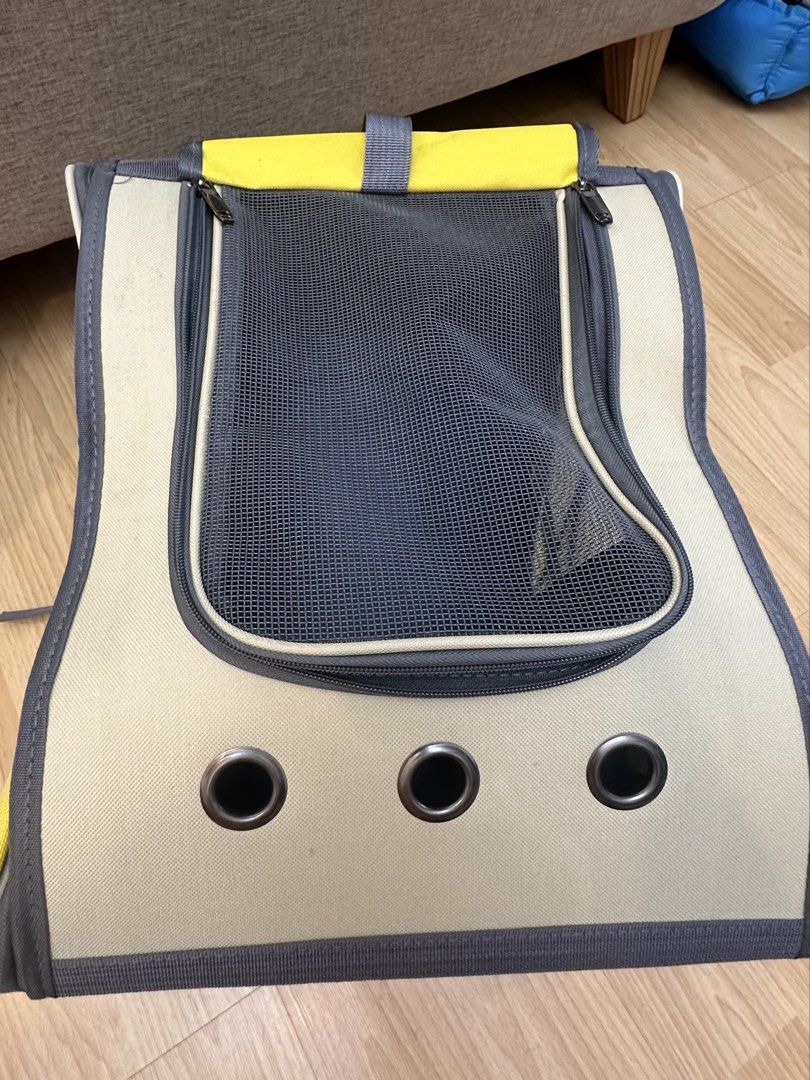 Yellow and beige pet carrier backpack (Category: Homes & Other Pet Accessories) located in Mandaluyong City. Submitted by mathizer3086 (Listing ID 1465397604, Image 1). Description: Yellow and beige pet carrier backpack with breathable mesh front panel and ventilation holes at the bottom. Includes a removable base pad for easy cleaning. Convenient top handle and zippered entry for loading your cat or small dog safely. Compact and lightweight desi