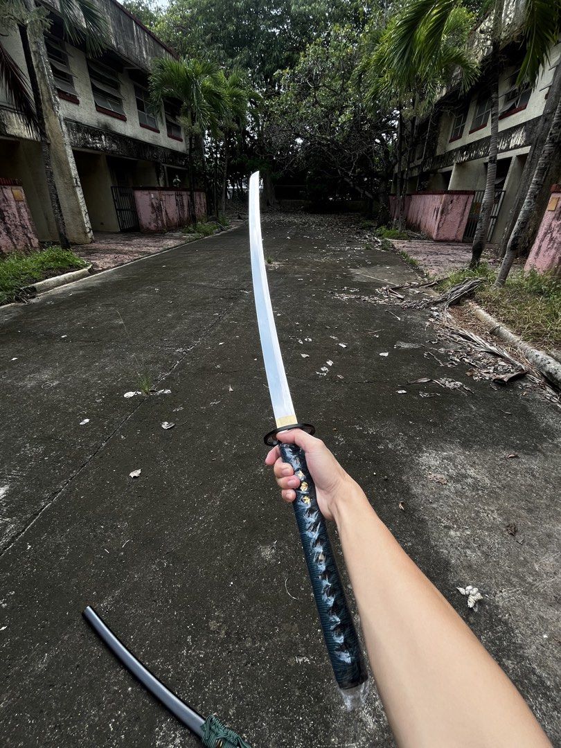 Yottsudomoe Katana (Category: Knives & Chopping Boards) located in Manila. Submitted by happyforest.16c523 (Listing ID 1465490139, Image 2). Description: Yottsudomoe Katana - 1095 Through-Tempered Katana Brand: Iron Tiger Forge Culture: Japanese Pommel: N/A Overall Length: 39 3/4” Blade Length: 28 3/4” Blade: 1095 High Carbon Steel Weight: 2 lbs 7 oxz Edge: Very Sharp P.O.B.: 6 1/8” Thickness: 7.5 mm - 6 mm Width: 32 mm Grip Length: 9 3/4” Class: