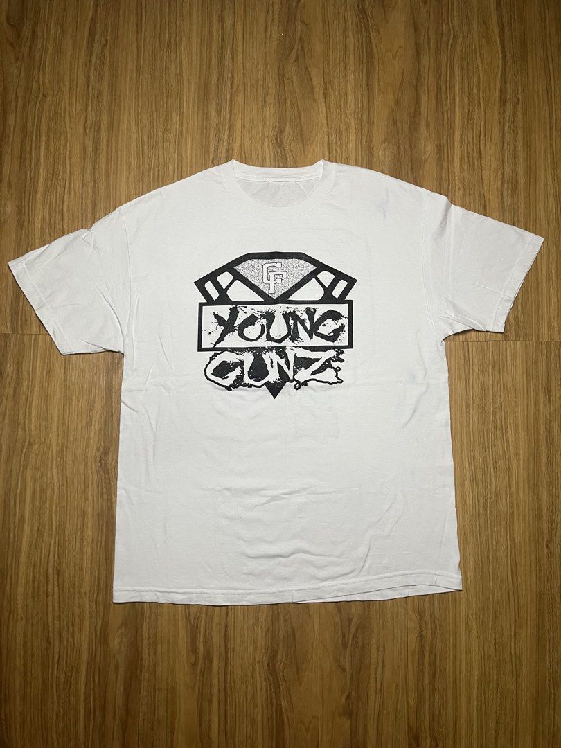 Young Gunz Graphic Tee White 23x31 (Category: Tshirts & Polo Shirts ) located in Cebu City. Submitted by guttathreads (Listing ID 1465429806, Image 1). Description: - Style: Casual streetwear white t-shirt - Design: 'Young Gunz' and 'CF' diamond graphic on front - Back: Large textured dot-pattern 'CF' logo - Fit: Short sleeves with a classic crew neck - Condition: Brand new / Excellent quality.