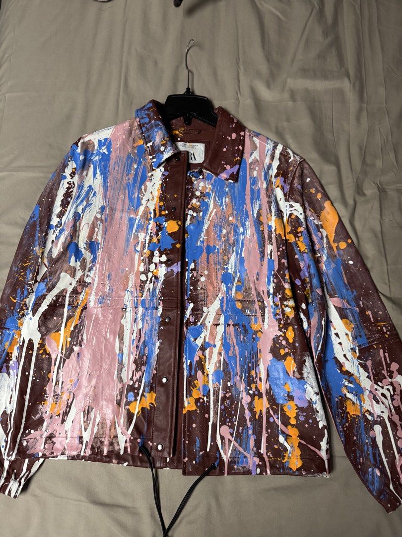 Zara A/W 2021 Collection Paint Splatter Leather Jacket (Category: Coats, Jackets and Outerwear) located in Manila. Submitted by seangoart (Listing ID 1465513189, Image 1). Description: - Brand: Zara (Autumn/Winter 2021 Collection) - Style: Brown faux leather jacket with bold, all-over paint splatter design (white, blue, pink, orange, purple) - Size: Large - Features: Front button closure and adjustable drawstring hem - Condition: Excellent statem