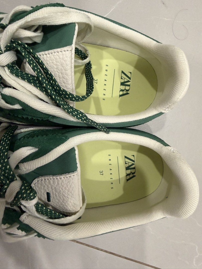 Zara Green Sneakers Size 37 (Category: Sneakers) located in Talisay. Submitted by itslucym (Listing ID 1465418220, Image 2). Description: - Brand/Model: Zara Green Sneakers - Size: EU 37 - Material: Mixed fabric finish with stylish suede overlays - Design: Contrast white stripes on the sides - Laces: Includes both speckled green laces and classic white laces - Soles: White textured outer soles with normal signs of wear underneath - Like new, worn