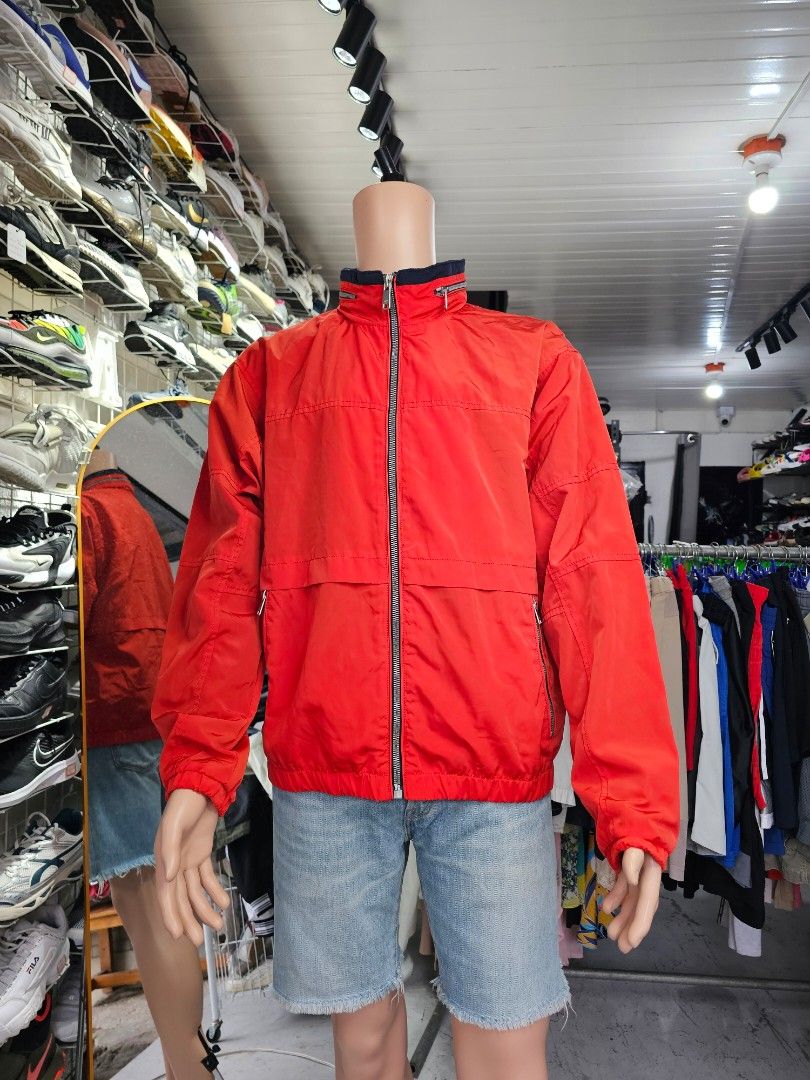 Zara Man Technical Windbreaker Jacket (Category: Coats, Jackets and Outerwear) located in Baguio. Submitted by kayeonlineshop (Listing ID 1465431284, Image 2). Description: -Zara Men's Red Technical Windbreaker Jacket featuring a distinctive dark navy blue contrast inner collar lining and a concealed zip-away hood. -lightweight, utilitarian outerwear piece designed for transitional weather. It features a minimalist, athletic aesthetic combined wi