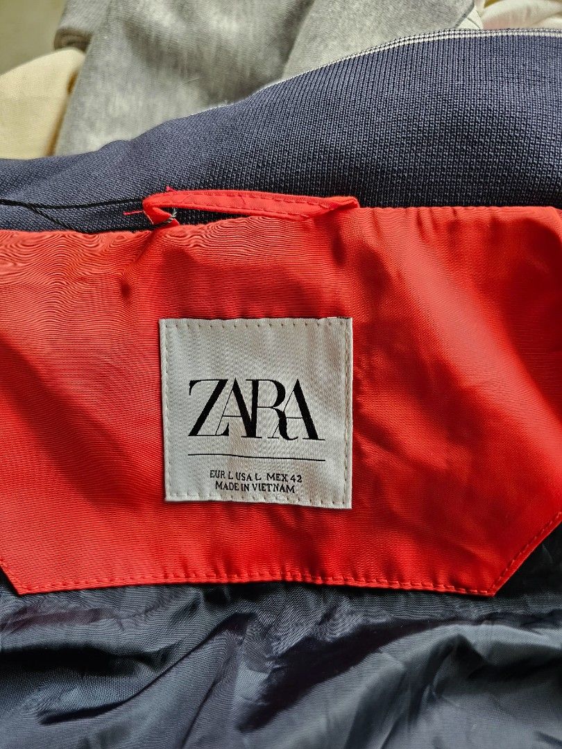 Zara Man Technical Windbreaker Jacket (Category: Coats, Jackets and Outerwear) located in Baguio. Submitted by kayeonlineshop (Listing ID 1465431284, Image 3). Description: -Zara Men's Red Technical Windbreaker Jacket featuring a distinctive dark navy blue contrast inner collar lining and a concealed zip-away hood. -lightweight, utilitarian outerwear piece designed for transitional weather. It features a minimalist, athletic aesthetic combined wi