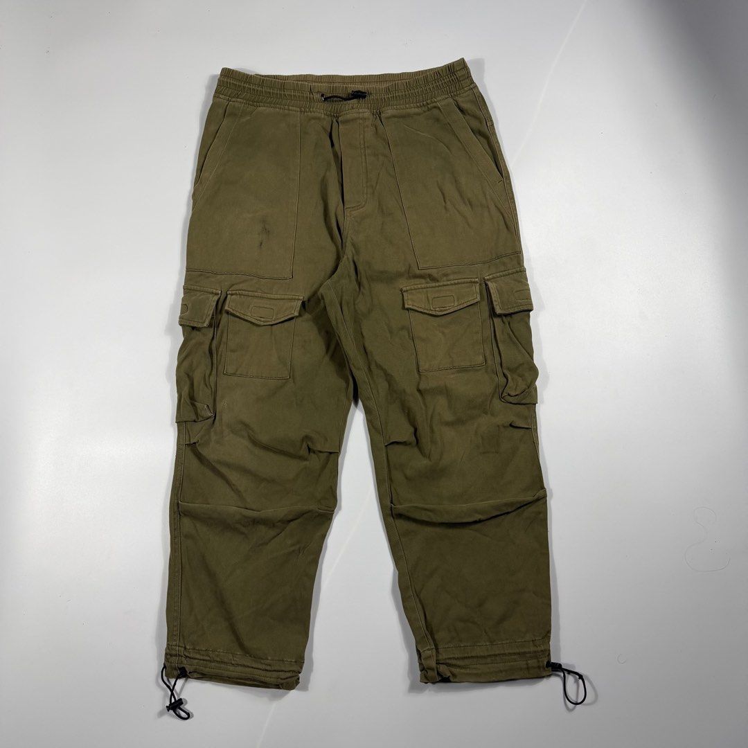 Zara Olive Green Multiple Pocket Cargo Pants (Category: Jeans) located in Bacolod City. Submitted by freshstuff13 (Listing ID 1465502561, Image 1). Description: - Brand: Zara - Size: M (Regular fit) - Color: Olive green / Earthy khaki - Material: Mid-weight cotton - Waist: Elastic with adjustable drawstring - Pockets: Multiple utility pockets on sides and back - Cuffs: Adjustable drawstrings at ankles.