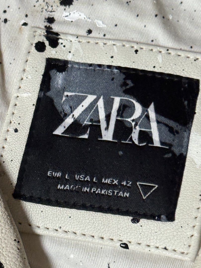 Zara Paint Splatter Faux Leather Biker Jacket (Category: Coats, Jackets and Outerwear) located in Manila. Submitted by seangoart (Listing ID 1465511259, Image 3). Description: White faux leather biker jacket from Zara. Covered in black and white paint splatter design all over. Asymmetrical front zipper, zipped pockets, and lapel collar. Size L. Made in Pakistan. Statement piece with an edgy street style look. Heavy paint drip details across the f