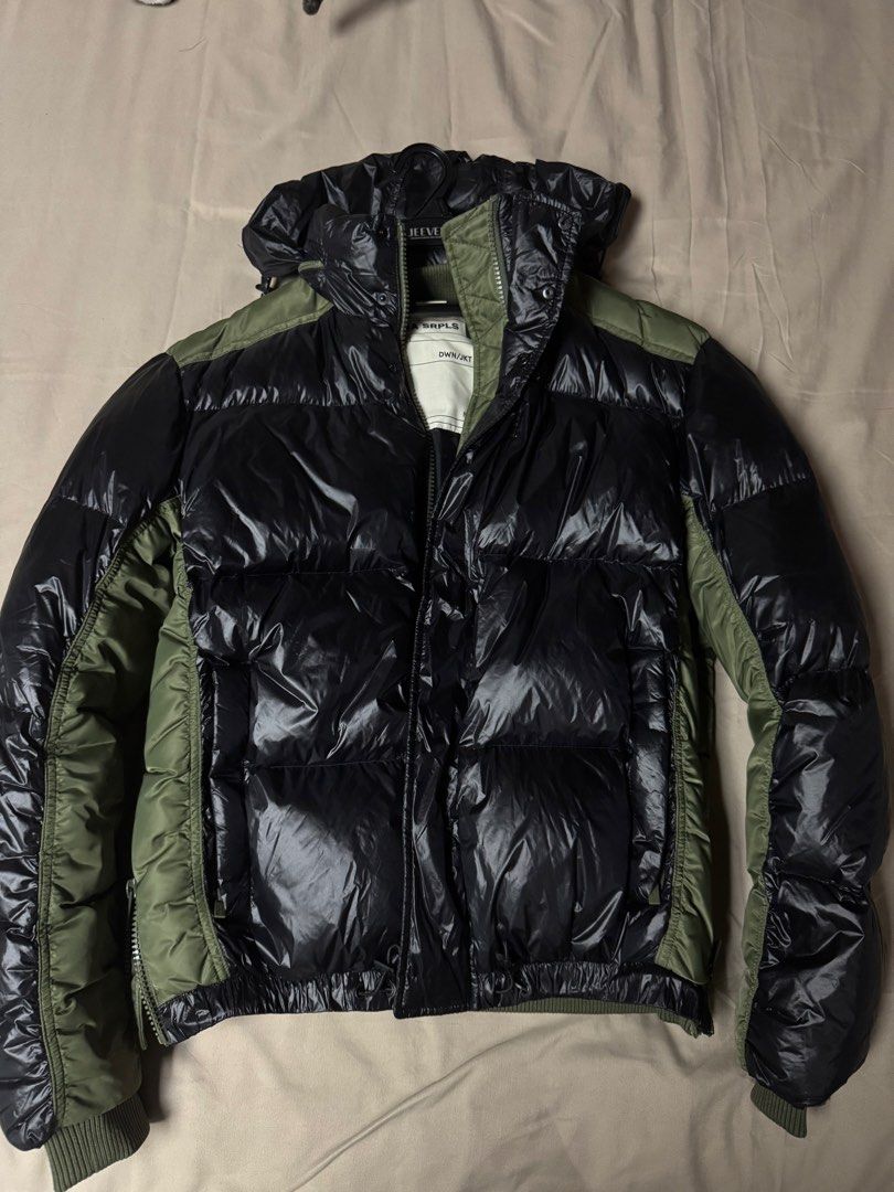 Zara Srpls Down Jacket 03 Nylon Black Olive Green (Category: Coats, Jackets and Outerwear) located in Manila. Submitted by seangoart (Listing ID 1465500446, Image 1). Description: - Brand: Zara SRPLS (DWN/JKT 03) - Color: Glossy black with olive green contrast panels - Features: Hooded design, zip-up front, secure interior pocket, and ribbed knit cuffs - Style: Military surplus aesthetic, trendy winter outerwear - Origin: Made in Indonesia - Cond