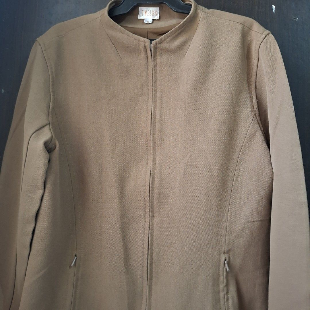 Zip-Up Collarless Jacket (Category: Coats, Jackets and Outerwear) located in Caloocan City. Submitted by mei56313 (Listing ID 1465392168, Image 2). Description: - preloved jacket - size S to M - color brown/tan/camel - good condition, working zippers, with signs of natural wear.