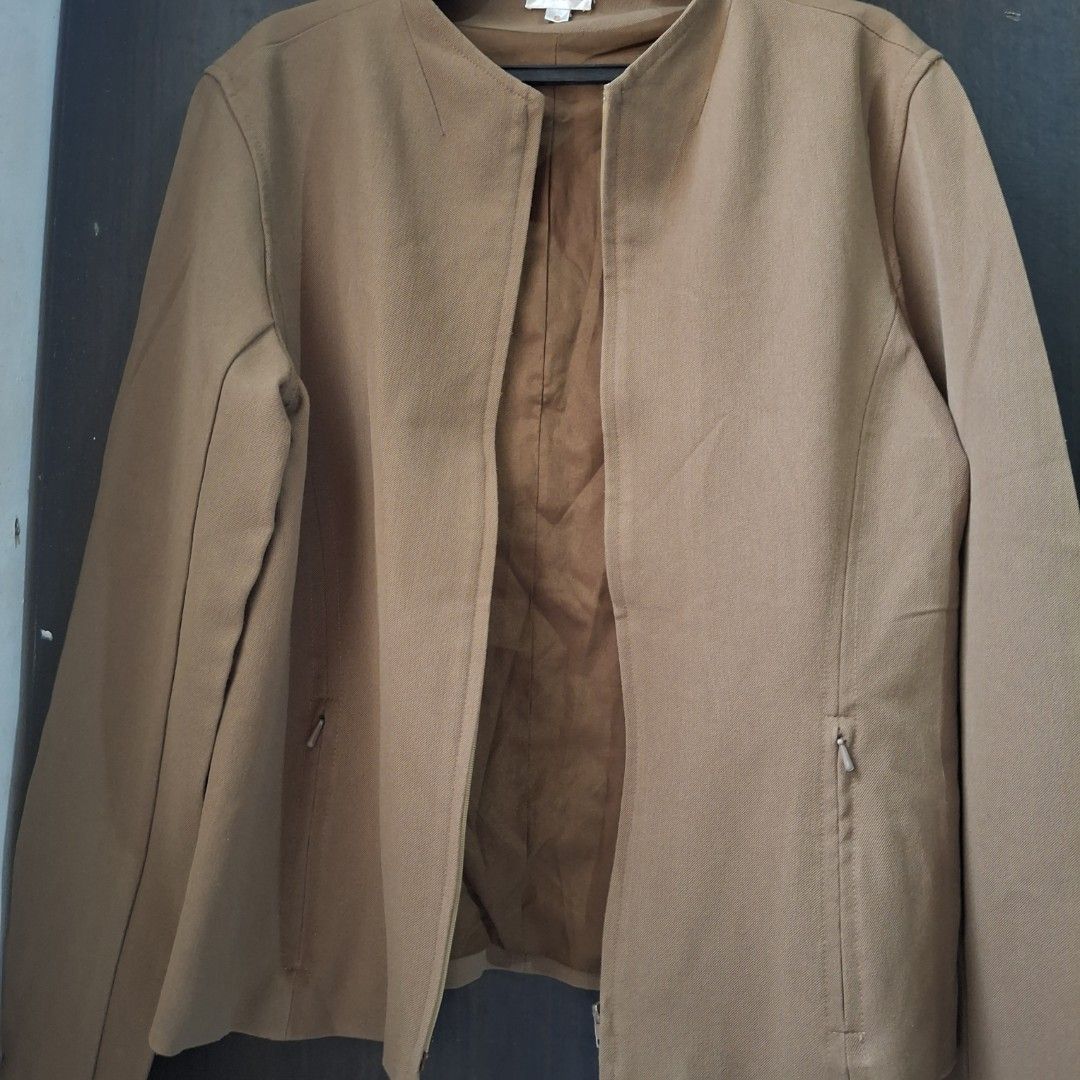 Zip-Up Collarless Jacket (Category: Coats, Jackets and Outerwear) located in Caloocan City. Submitted by mei56313 (Listing ID 1465392168, Image 1). Description: - preloved jacket - size S to M - color brown/tan/camel - good condition, working zippers, with signs of natural wear.