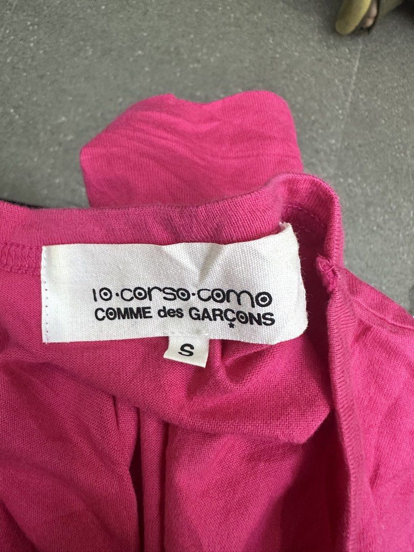 10 Corso Como Comme des Garcons Pink Number Graphic Tee (Category: Shirts) located in Manila. Submitted by declutterpromax (Listing ID 1469214617, Image 3). Description: - Brand: 10 Corso Como x Comme des Garcons - Color: Pink with white graphic print - Size: Small (Measures approx. 18" chest, 24" length) - Material: 100% cotton, Made in Japan - Details: Model code SB-T907, AD2008 release - Care: Hand wash only.