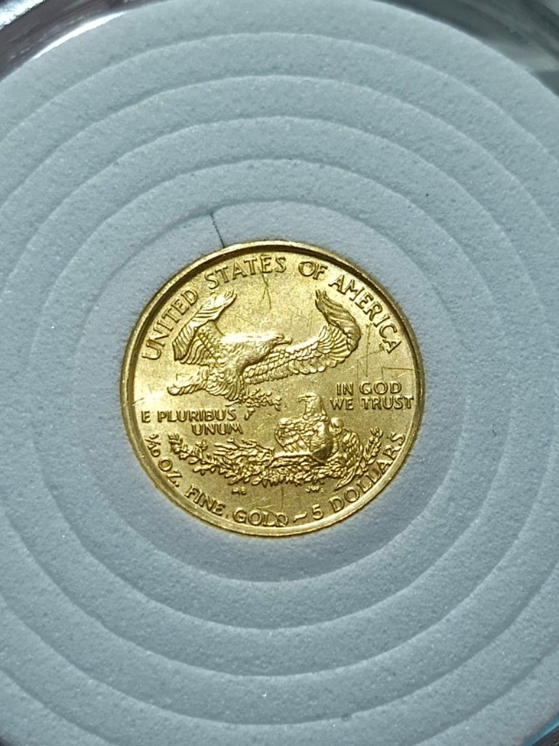 1999 1/10 oz US Gold Eagle 5 Dollars Coin (Category: Currency) located in Quezon City. Submitted by Coiners (Listing ID 1469352403, Image 2). Description: - Authentic 1999 US American Eagle gold coin ($5 face value) - Contains 1/10 oz of fine gold - Features iconic Lady Liberty on the obverse and eagle on the reverse - Stored securely in a protective round coin capsule with foam insert - Genuine US Mint bullion piece, ideal for stacking or collec