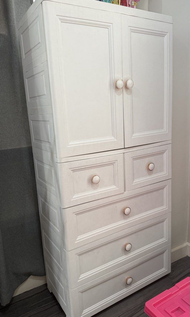 2 Door Cabinet with 5 Drawers (Category: Shelves, Cabinets & Racks) located in Manila. Submitted by nic_declutter (Listing ID 1469236476, Image 2). Description: White 2 Door Cabinet with 5 drawers 156x65x38cm Has bottom load-bearing pulley Has stainless steel clothes hanging rod Material: PP material without bisphenol A, heat-resistant, environmentally friendly and reassuring, Soft hardness is more suitable for shaping Ps: Caps displayed are not 
