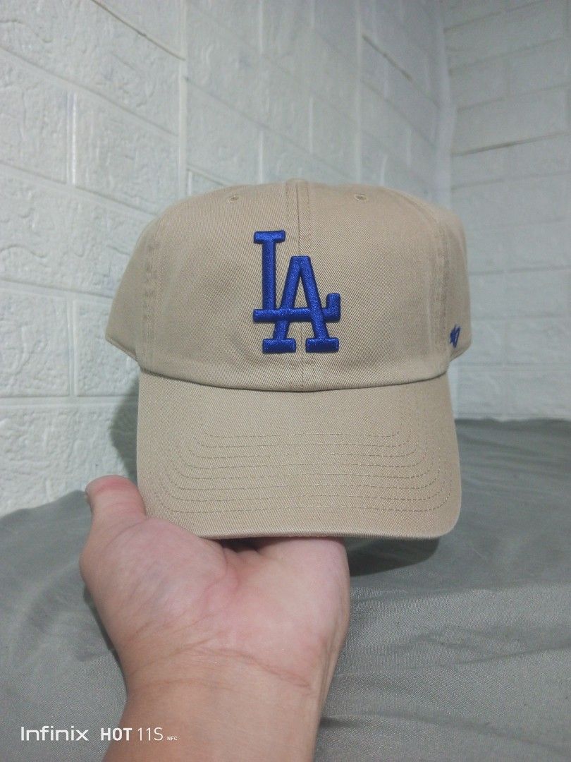 '47 Brand Los Angeles Dodgers Cap Tan (Category: Caps & Hats) located in Las Pinas. Submitted by rzzr_thrift25 (Listing ID 1469355128, Image 1). Description: - Authentic '47 Brand Los Angeles Dodgers baseball cap - Color: Khaki/tan cotton twill with royal blue embroidered LA logo - Small '47 logo embroidered on the left side - Adjustable strapback closure with brass metal slide buckle for a custom fit - Includes internal foam insert to maintain s
