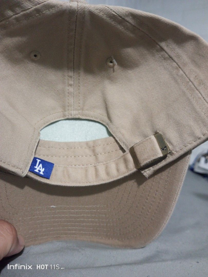 '47 Brand Los Angeles Dodgers Cap Tan (Category: Caps & Hats) located in Las Pinas. Submitted by rzzr_thrift25 (Listing ID 1469355128, Image 3). Description: - Authentic '47 Brand Los Angeles Dodgers baseball cap - Color: Khaki/tan cotton twill with royal blue embroidered LA logo - Small '47 logo embroidered on the left side - Adjustable strapback closure with brass metal slide buckle for a custom fit - Includes internal foam insert to maintain s