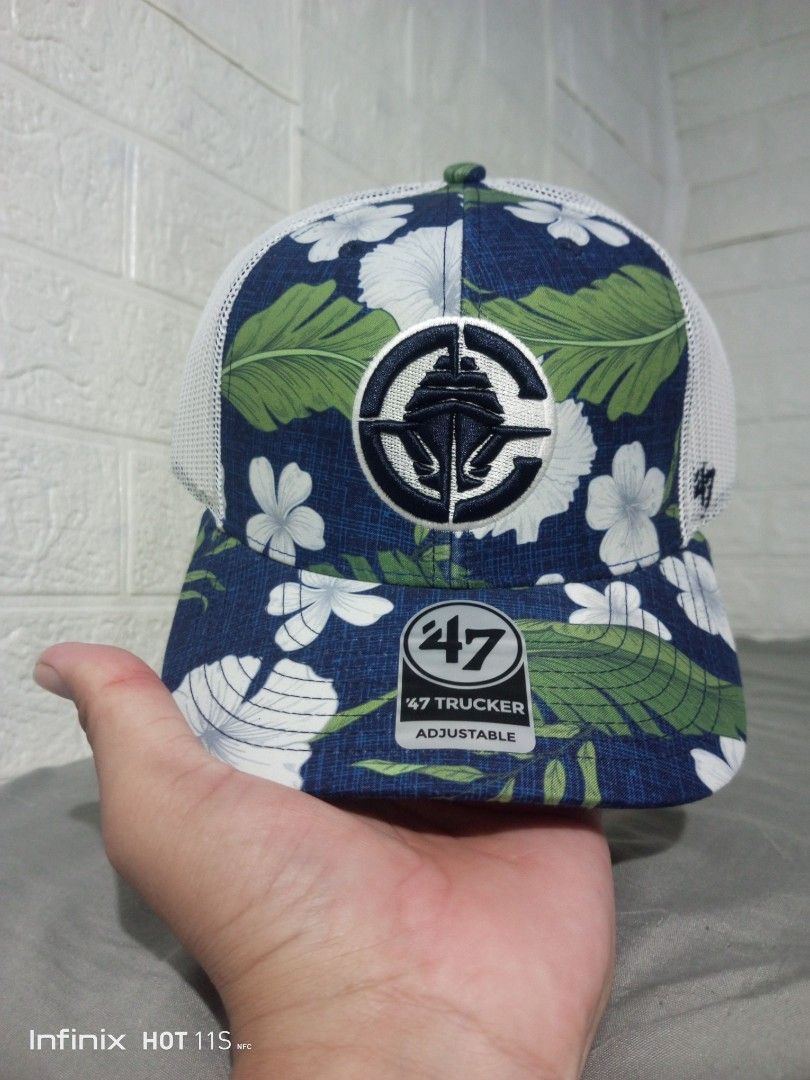 '47 Los Angeles Clippers Beach Side Trucker Hat (Category: Caps & Hats) located in Las Pinas. Submitted by rzzr_thrift25 (Listing ID 1469355451, Image 1). Description: Los Angeles Clippers trucker hat from '47 Brand. Navy blue base with a vibrant floral and tropical leaf pattern. White mesh back panels and white snapback closure. Front features a circular embroidered Clippers ship logo patch. Official '47 sticker on the brim. Brand new condition 