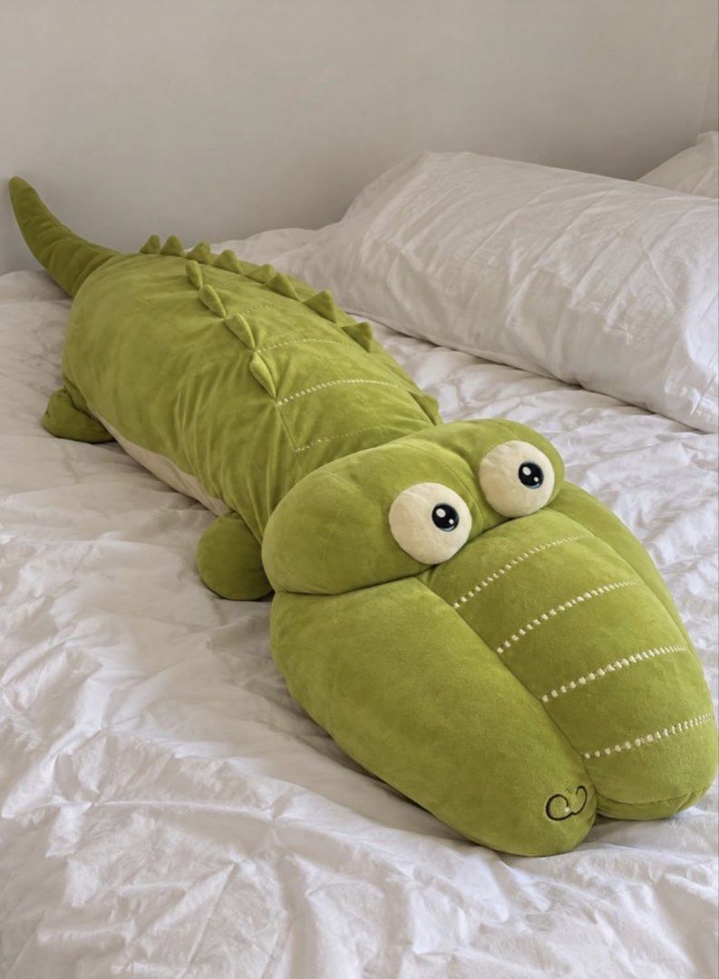 4ft crocodile plush pillow (Category: Plushies & Soft Toys) located in Pasig City. Submitted by ponyo_ph (Listing ID 1469254598, Image 1). Description: - Item: Giant Green Crocodile Plush Toy - Size/Use: Perfect for hugging or using as a cozy body pillow - Features: Big round eyes and cute stitched details down the back and tail - Condition: needs to be washed - Perfect for: Adding a fun touch to any bed or couch.