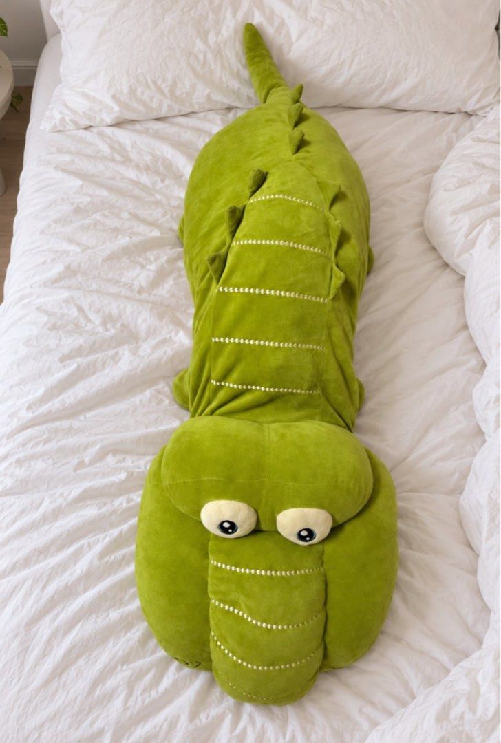 4ft crocodile plush pillow (Category: Plushies & Soft Toys) located in Pasig City. Submitted by ponyo_ph (Listing ID 1469254598, Image 2). Description: - Item: Giant Green Crocodile Plush Toy - Size/Use: Perfect for hugging or using as a cozy body pillow - Features: Big round eyes and cute stitched details down the back and tail - Condition: needs to be washed - Perfect for: Adding a fun touch to any bed or couch.