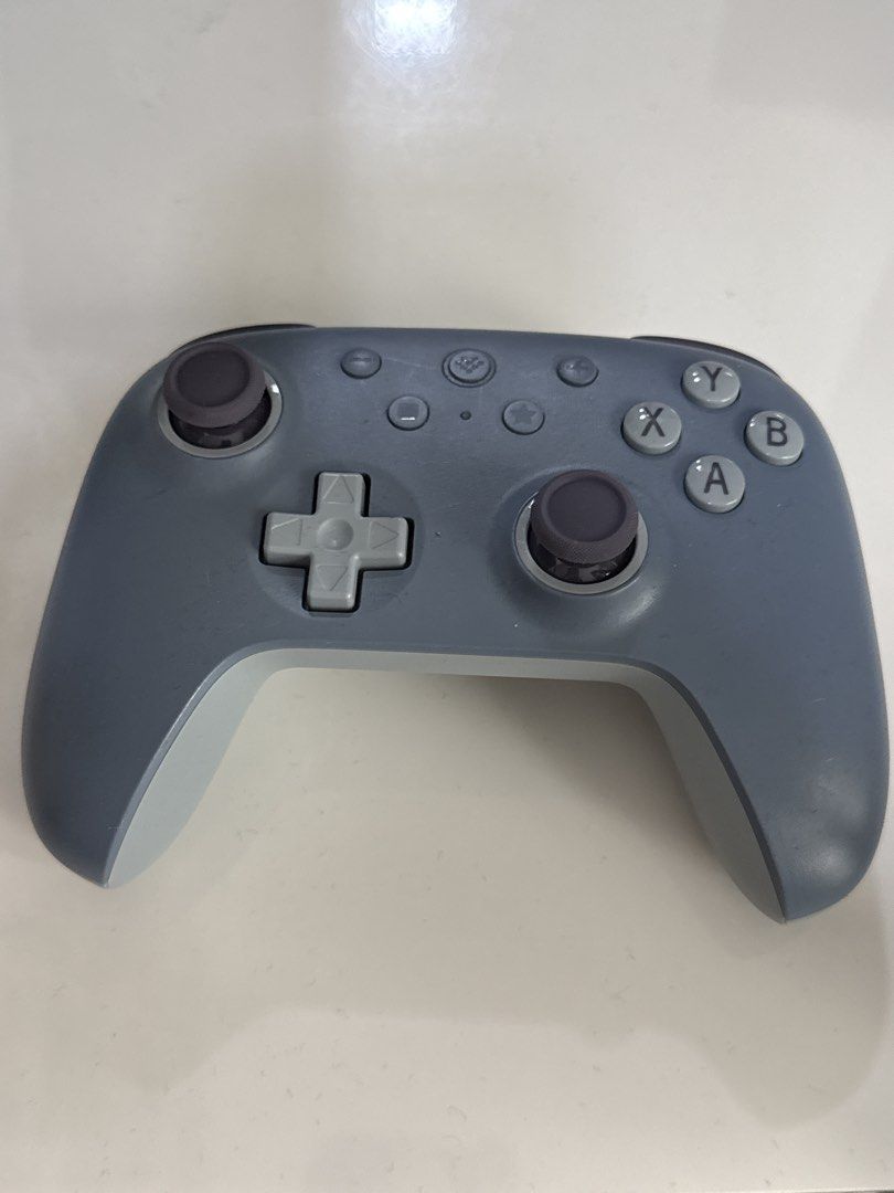 8BitDo Ultimate 2C Wireless Controller Grey (Category: Controllers) located in Kuala Lumpur. Submitted by komi2311 (Listing ID 1469218190, Image 3). Description: - Model: 8BitDo Ultimate 2C Wireless Controller - Color: Grey body with dark grey thumbsticks and D-pad - Connectivity: Bluetooth and 2.4G support - Layout: Standard face button configuration.