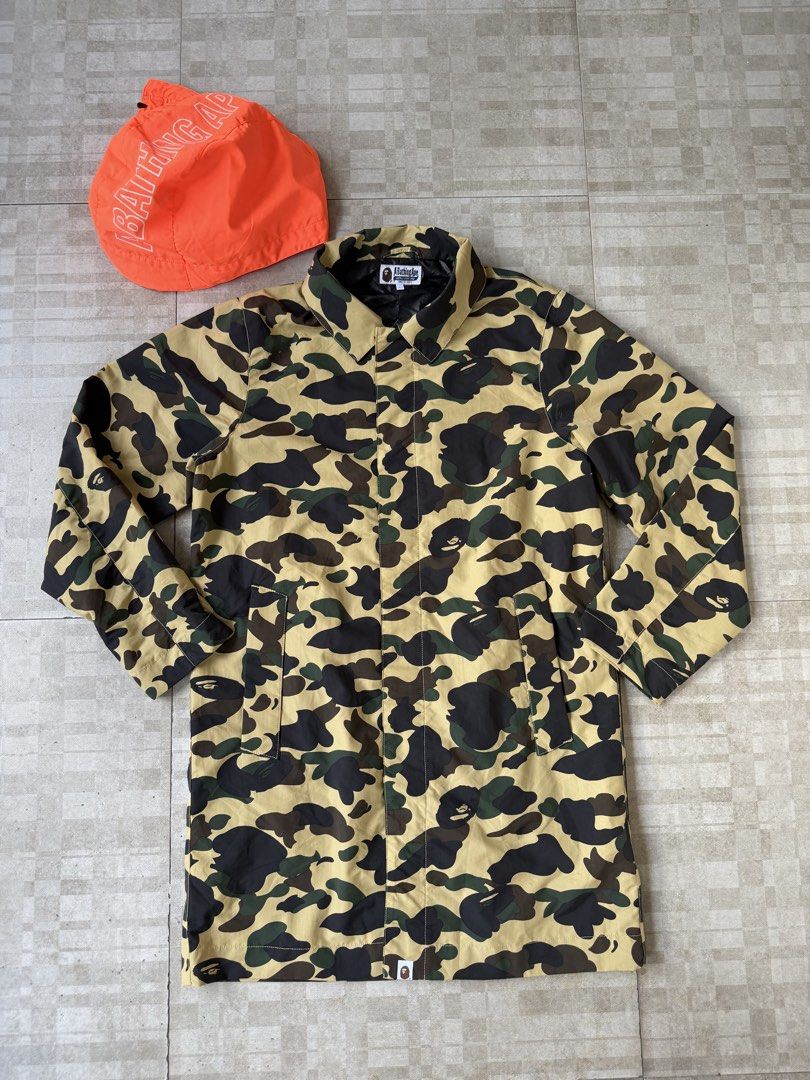 A Bathing Ape BAPE 1st Camo Long Mod Coat/Trench Jacket (Category: Coats, Jackets and Outerwear) located in Cavite. Submitted by PRIVATE.Selection (Listing ID 1469192828, Image 2). Description: A Bathing Ape BAPE 1st Camo Long Mod Coat/Trench Jacket Detachable Hood Size Large W- 23 L- 38 Good as new Condition .