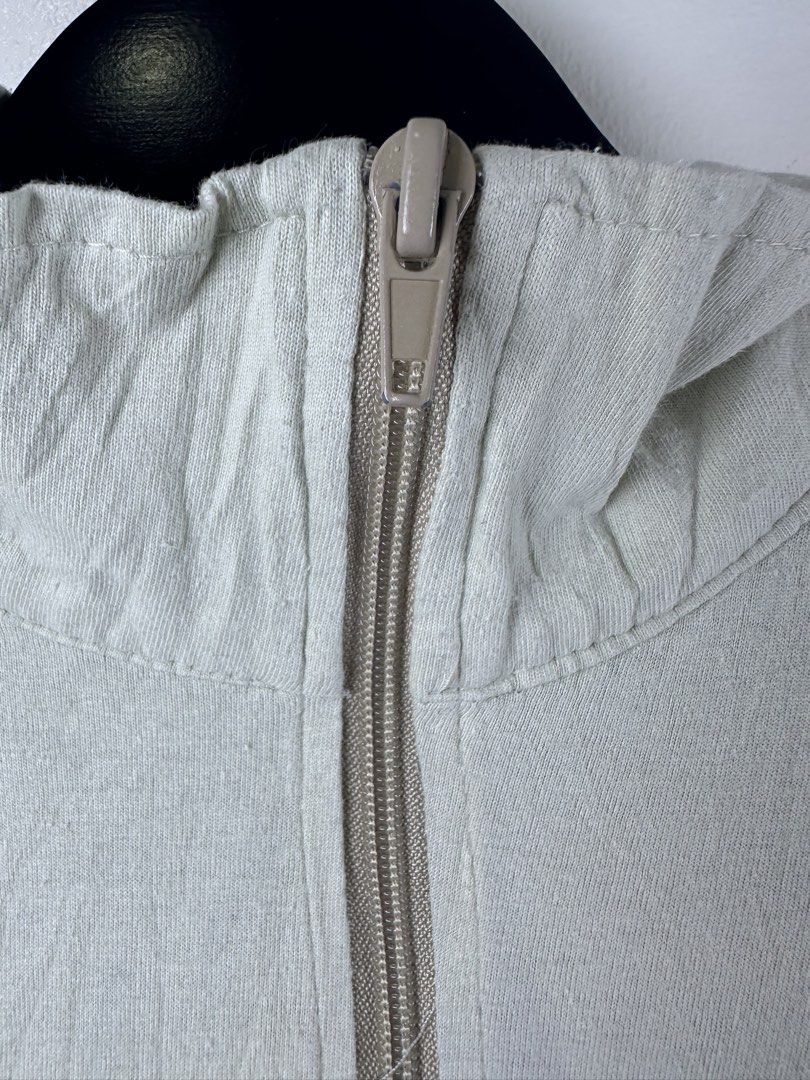 A Bathing Ape BAPE Zip Up Jacket (Category: Coats, Jackets and Outerwear) located in Manila. Submitted by declutterpromax (Listing ID 1469215644, Image 3). Description: - Brand: A Bathing Ape (BAPE) - Color: Off-white with black and beige contrast details - Design: Small Bape head graphic on chest, large Bape head and text on back - Features: Full-zip closure, contrast black stripes on sleeves, dual front slip pockets - Trim: Beige ribbed collar,