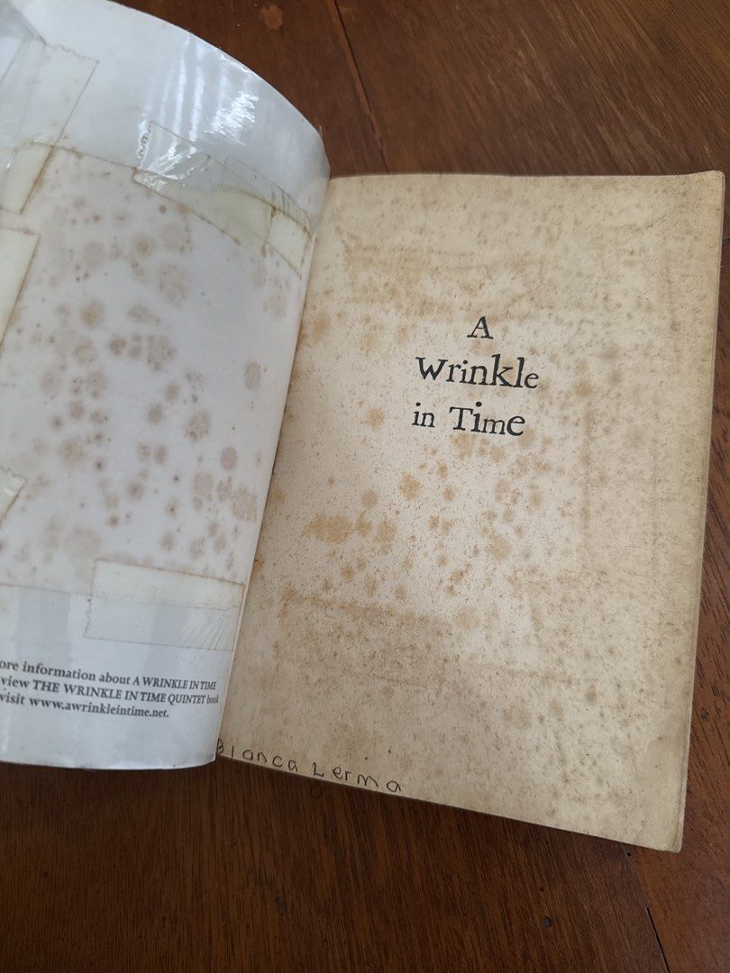 A Wrinkle in Time by Madeleine L'Engle (Category: Storybooks) located in Santo Tomas. Submitted by toughu (Listing ID 1469223111, Image 2). Description: - Title & Author: A Wrinkle in Time by Madeleine L'Engle - Publisher: Square Fish (Paperback) - Genre: Classic Children's Fantasy / Space-Time Travel - Condition: Heavily used, tanning and foxing on pages, taped cover protector, handwritten name on the inside - Readability: All pages are fully in