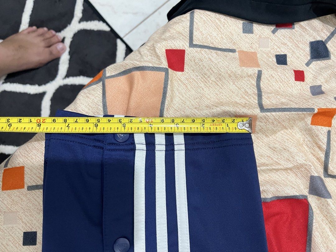 Adidas Blue Button-Up Track Pants Size M (Category: Joggers) located in Adams. Submitted by m1k3yl (Listing ID 1469215984, Image 1). Description: - Brand: Adidas - Color: Navy blue with white side stripes - Size: Medium - Features: Full button snaps along outer legs, elastic waistband with adjustable drawstring, and two side pockets - Origin: Made in Indonesia - Condition/Use: Great for sports, workouts, or everyday chilling.