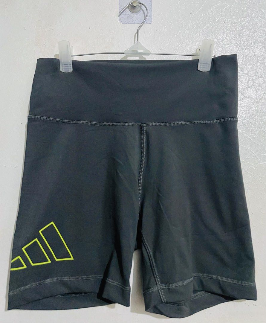 Adidas Grey Biker Shorts (Category: Shorts) located in Caloocan City. Submitted by lovemyclothes21 (Listing ID 1469265624, Image 1). Description: - Brand: Adidas - Color: Dark grey with bright yellow logo - Size: Medium on tag (best fits waist 24 to 28 inches) - Fit: High-waisted with comfortable, stretchy activewear material - Features: Adidas Aeroready branding on the back - Condition/Origin: Interior wash tags intact, made in Myanmar - Ideal f