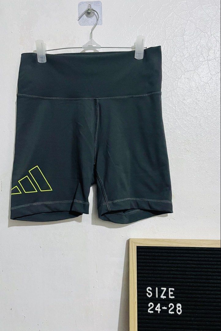 Adidas Grey Biker Shorts (Category: Shorts) located in Caloocan City. Submitted by lovemyclothes21 (Listing ID 1469265624, Image 2). Description: - Brand: Adidas - Color: Dark grey with bright yellow logo - Size: Medium on tag (best fits waist 24 to 28 inches) - Fit: High-waisted with comfortable, stretchy activewear material - Features: Adidas Aeroready branding on the back - Condition/Origin: Interior wash tags intact, made in Myanmar - Ideal f