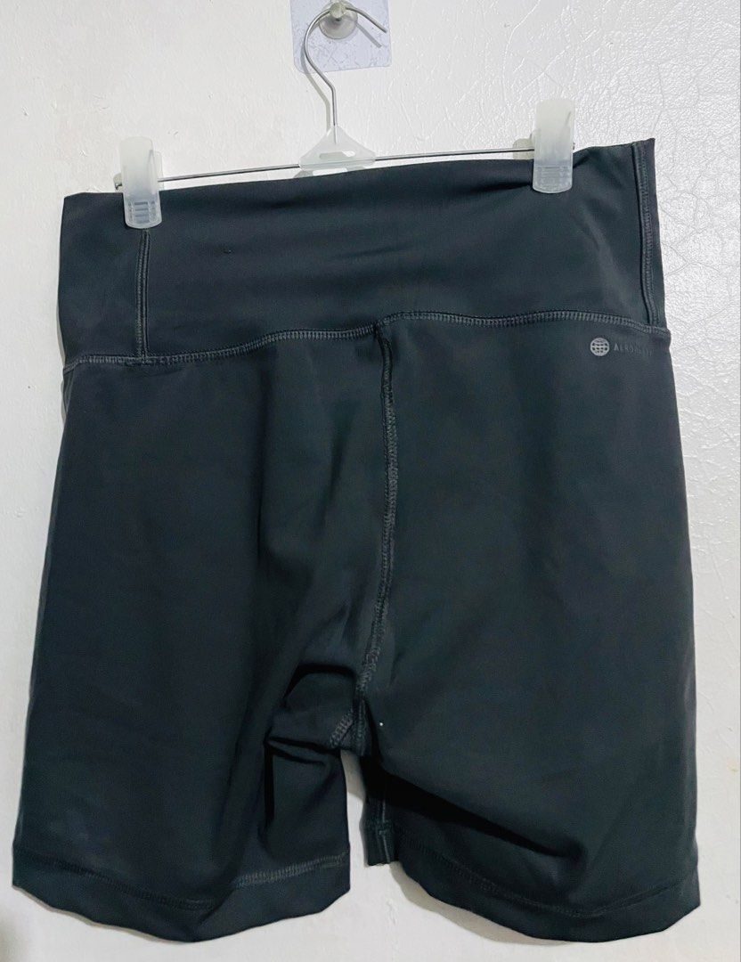 Adidas Grey Biker Shorts (Category: Shorts) located in Caloocan City. Submitted by lovemyclothes21 (Listing ID 1469265624, Image 3). Description: - Brand: Adidas - Color: Dark grey with bright yellow logo - Size: Medium on tag (best fits waist 24 to 28 inches) - Fit: High-waisted with comfortable, stretchy activewear material - Features: Adidas Aeroready branding on the back - Condition/Origin: Interior wash tags intact, made in Myanmar - Ideal f