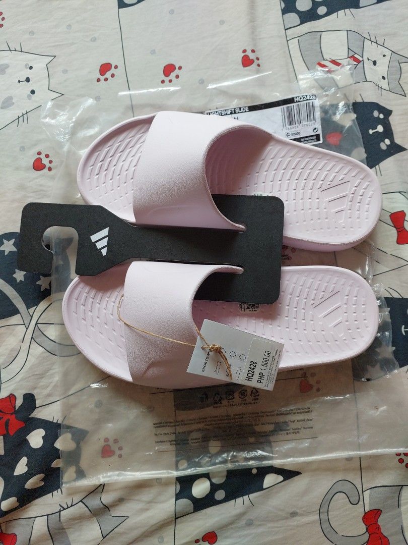 Adidas Lightshift Slide Pink Size UK 6 (Category: Slippers and slides) located in Cebu City. Submitted by choithrift0326 (Listing ID 1469170011, Image 3). Description: - Brand: Adidas - Model: Lightshift (HQ2428) - Color: Pink - Size: US 6 / UK 6 / EU 39 - Condition: Brand new, never worn - Inclusions: Original retail tag (PHP 1,500.00) and original plastic packaging with hanger.