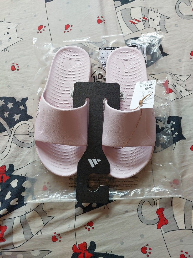 Adidas Lightshift Slide Pink Size UK 6 (Category: Slippers and slides) located in Cebu City. Submitted by choithrift0326 (Listing ID 1469170011, Image 2). Description: - Brand: Adidas - Model: Lightshift (HQ2428) - Color: Pink - Size: US 6 / UK 6 / EU 39 - Condition: Brand new, never worn - Inclusions: Original retail tag (PHP 1,500.00) and original plastic packaging with hanger.