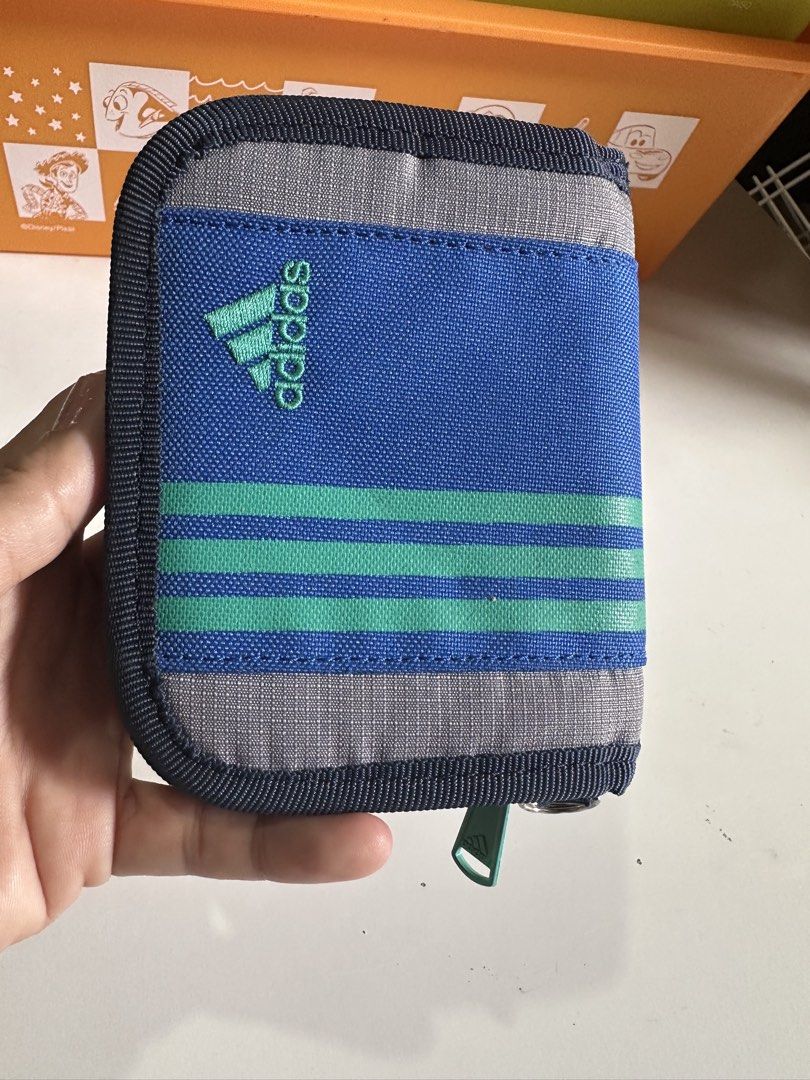 Adidas Multi pocketed Nylon Wallet (Category: Wallets & Card Holders) located in Davao. Submitted by favoritepreloved (Listing ID 1469201437, Image 1). Description: 💜 brand new condition, very clean 💜 fix price.