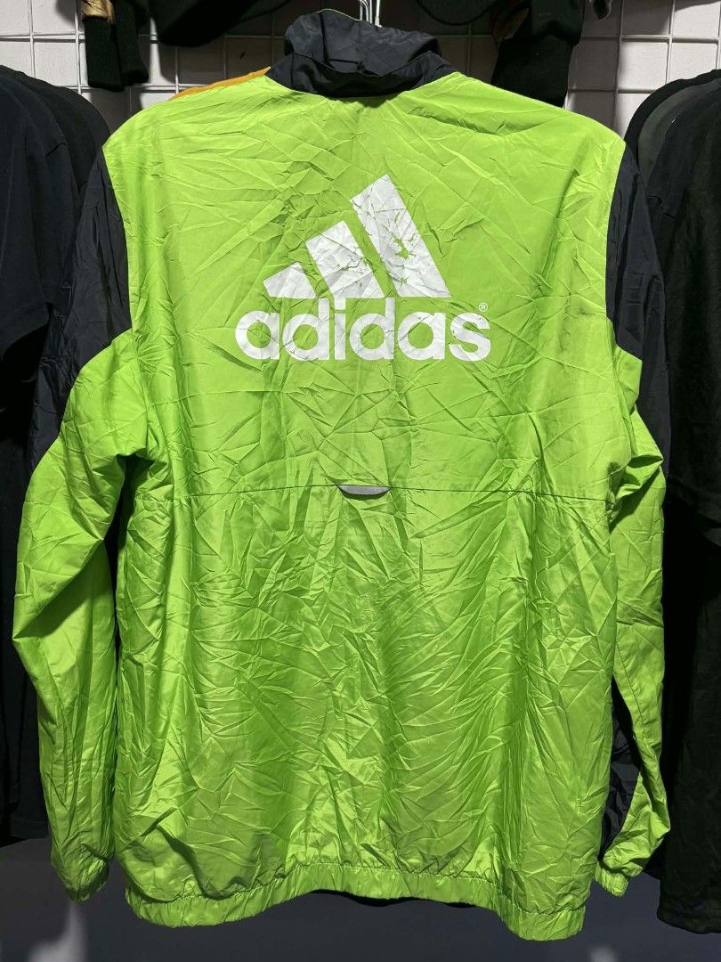 ADIDAS NEON WINDBREAKER JACKET (Category: Coats, Jackets and Outerwear) located in Bulacan. Submitted by annenicathriftthriftlang (Listing ID 1469198288, Image 3). Description: *ADIDAS NEON WINDBREAKER JACKET - BIG LOGO 💚🖤* *Size 164 on tag (165/80A) *DIMES:* - Width: 21-22 inch - Length: 26 inch - Sleeve: 24 inch - Shoulder: 18 inch - Fit: Medium to Large *CONDITION:* Good condition, lightweight windbreaker, working zipper, may konting crack s