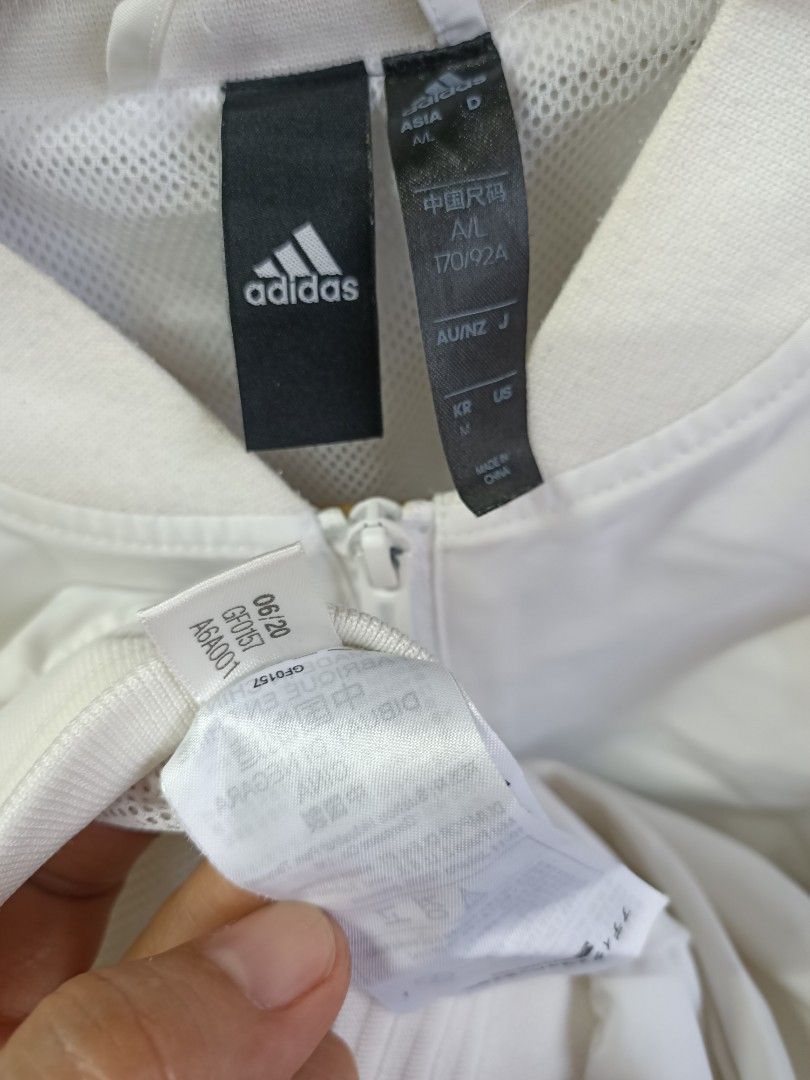 Adidas White Bomber Jacket With Big Back Logo (Category: Coats, Jackets and Outerwear) located in Bayombong. Submitted by rheaaa00530 (Listing ID 1469309994, Image 3). Description: - White Adidas bomber jacket in clean condition - Zip-up front with practical side pockets - Comfortable mesh lining inside - Ribbed collar, cuffs, and hem for a great fit - Eye-catching large black Adidas logo printed on the back - Size: Asia A/L (170/92A) / US M - Ma