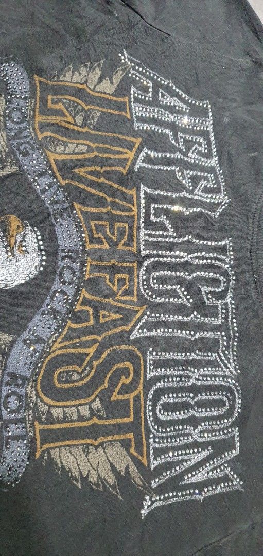 Affliction Live Fast Rhinestone Eagle Graphic T-Shirt (Category: Shirts) located in Laoag. Submitted by floydg_corpuz22 (Listing ID 1469255065, Image 3). Description: Affliction graphic tee with Y2K rocker vibes, featuring rhinestone accents, an eagle shield graphic, and a tie hem. Washed black with distressed details. Affliction for her Xs 17x18 Vgood to excellent need wash 350+sf.