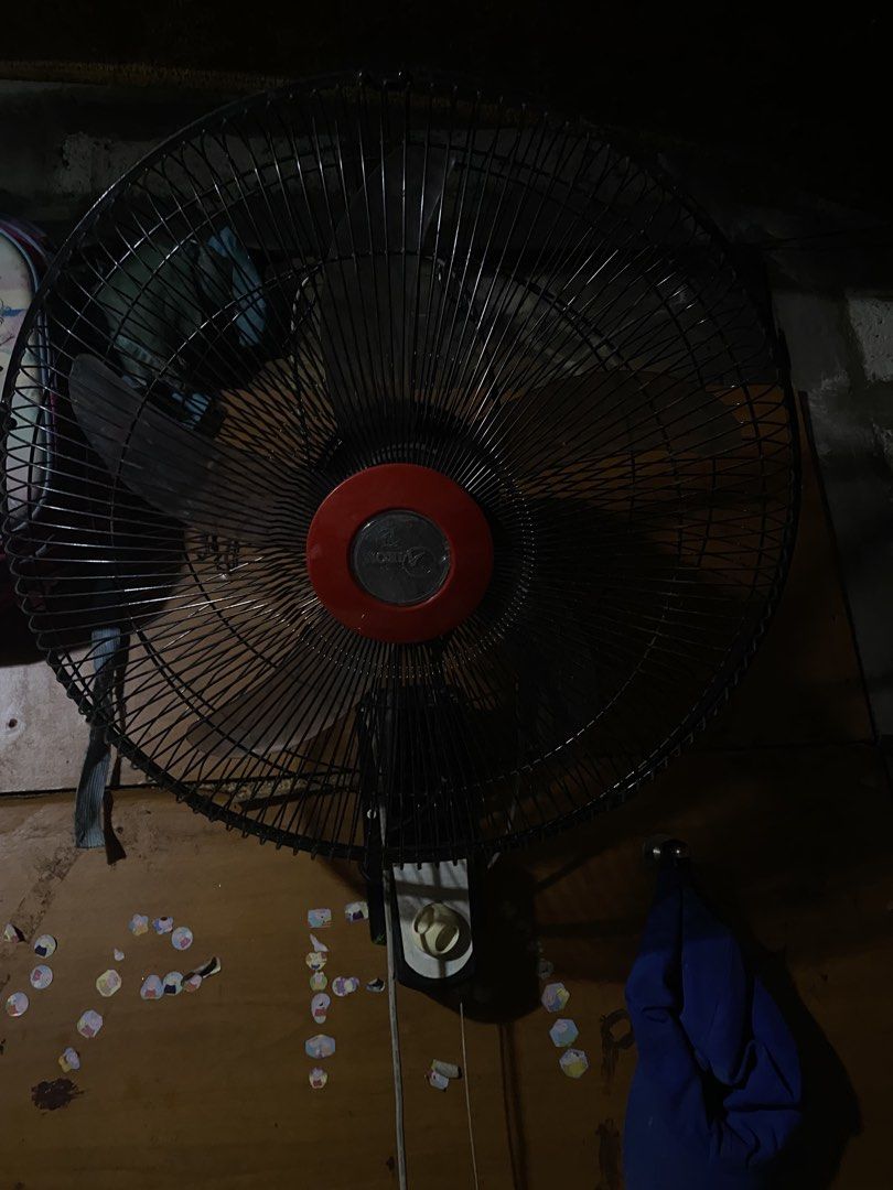 Aikon Wall Fan Black With Red Center (Category: Fans) located in San Jose del Monte. Submitted by zy420 (Listing ID 1469272897, Image 2). Description: - Color: Black with a striking red center cap - Blades: 4 translucent grey blades inside a sturdy protective wire cage - Controls: Easy-to-use bottom-mounted switch with pull strings - Condition: Fully operational and ready to use - Performance: Provides strong and reliable airflow to keep your roo