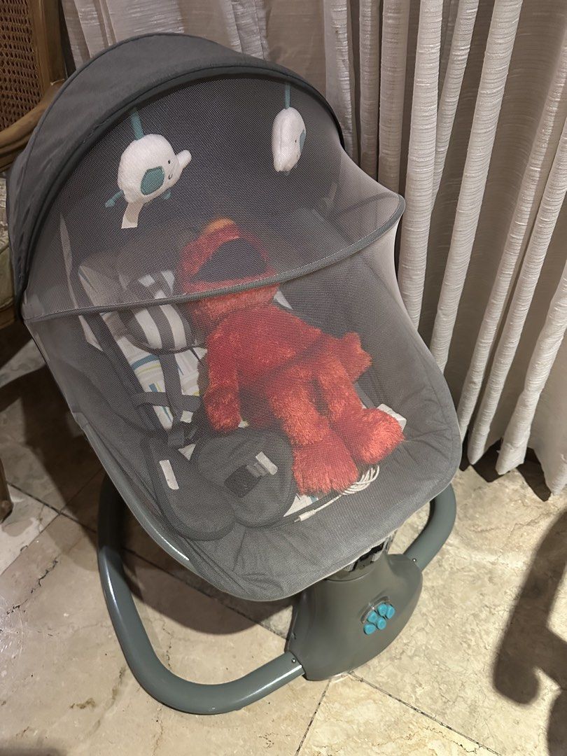 Akeeva Snuggli infant to toddler automatic snoozer swing (Category: Cots & Cribs) located in San Juan City. Submitted by smartfindsph (Listing ID 1469310415, Image 2). Description: - Brand: Akeeva Automatic Baby Rocker - Color: Grey - Condition: Clean and 100% working great - Features: Multi-speed control buttons on a sturdy base - Comfort: Soft patterned mattress pad with built-in head support - Safety: Secure harness straps included - Accessori