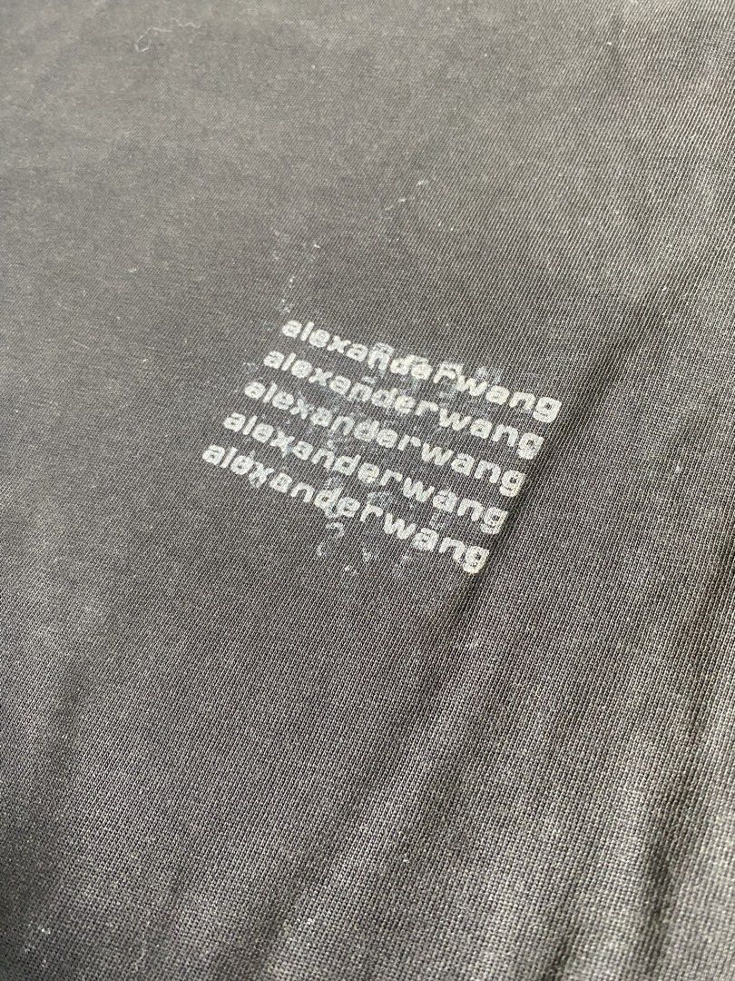 Alexander Wang Black Graphic Tee Size M (Category: Shirts) located in Caloocan City. Submitted by remythrift (Listing ID 1469202568, Image 3). Description: - Brand: Alexander Wang - Color: Black - Size: Medium - Material: 100% Cotton (Body and Rib) - Design: Classic crew neck, short sleeves, and subtle repeated logo print on the lower left front - Origin: Made in Vietnam - Condition: Great everyday basic for effortless styling.