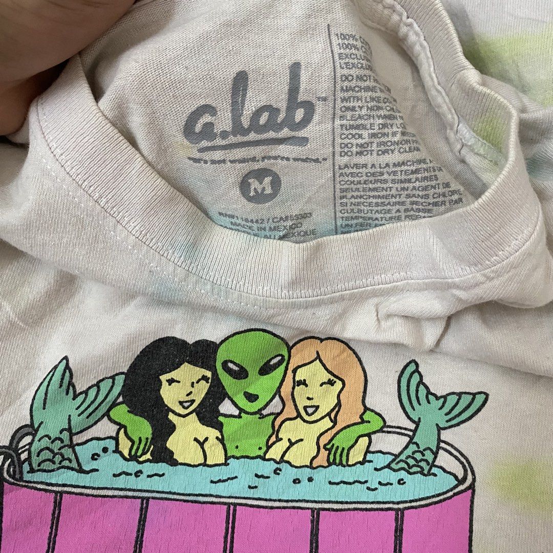 alien workshop (Category: Tshirts & Polo Shirts) located in Kuala Lumpur. Submitted by dee_bundle (Listing ID 1469250658, Image 3). Description: - Brand: A.Lab - Size: Medium (tag inside) - Color/Pattern: White with pastel blue and pink tie-dye stripes - Design: Alien & mermaids hot tub front graphic, large pool party back graphic - Material: 100% cotton (Made in Mexico).