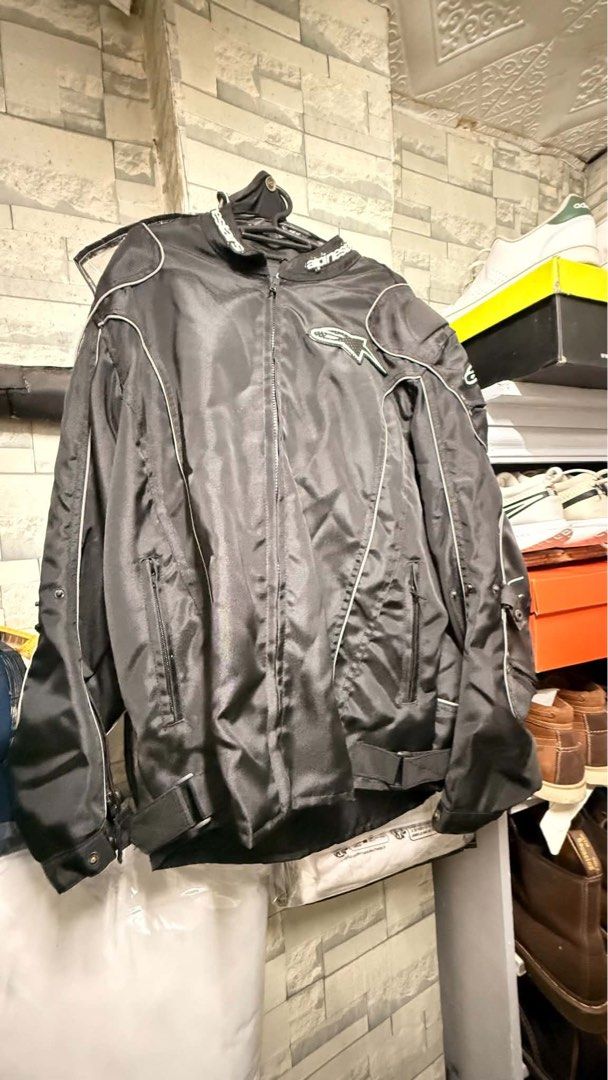 Alpinestars Black Motorcycle Jacket with Armor Pads (Category: Coats, Jackets and Outerwear) located in Makati City. Submitted by wallie_11 (Listing ID 1469166500, Image 2). Description: - Brand: Alpinestars - Color: Black with white piping - Protection: Includes removable armor pads for back, shoulders, and elbows - Features: Full front zip closure, zipped hand pockets, and adjustable waist straps - Condition: Durable, high-quality riding gear f