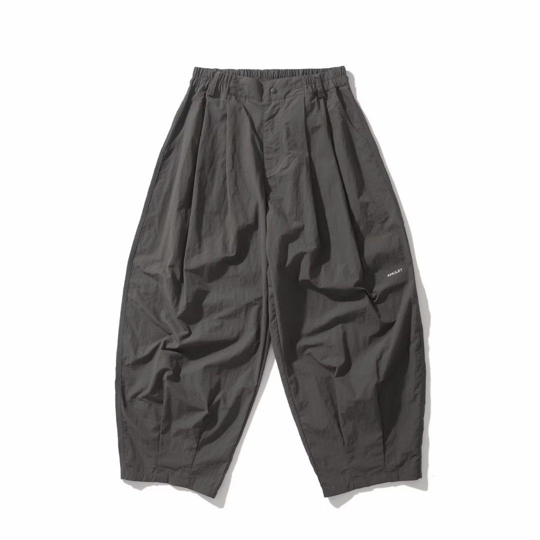 AMULET Balloon Chino Parachute Pants (Category: Trousers) located in Puerto Princesa. Submitted by terdsthrift (Listing ID 1468389424, Image 1). Description: AMULET Balloon Chino Parachute Pants - Grey Waist: 28-30 Length: 38 Thigh: 15.5 Hem: 11 In Excellent Condition / No Issue Color Rate: 10/10 - Brand: AMULET - Color: Dark Grey - Size: S - Fit: Wide, baggy silhouette with pleated front - Waist: Elastic waistband with zip fly and button closure