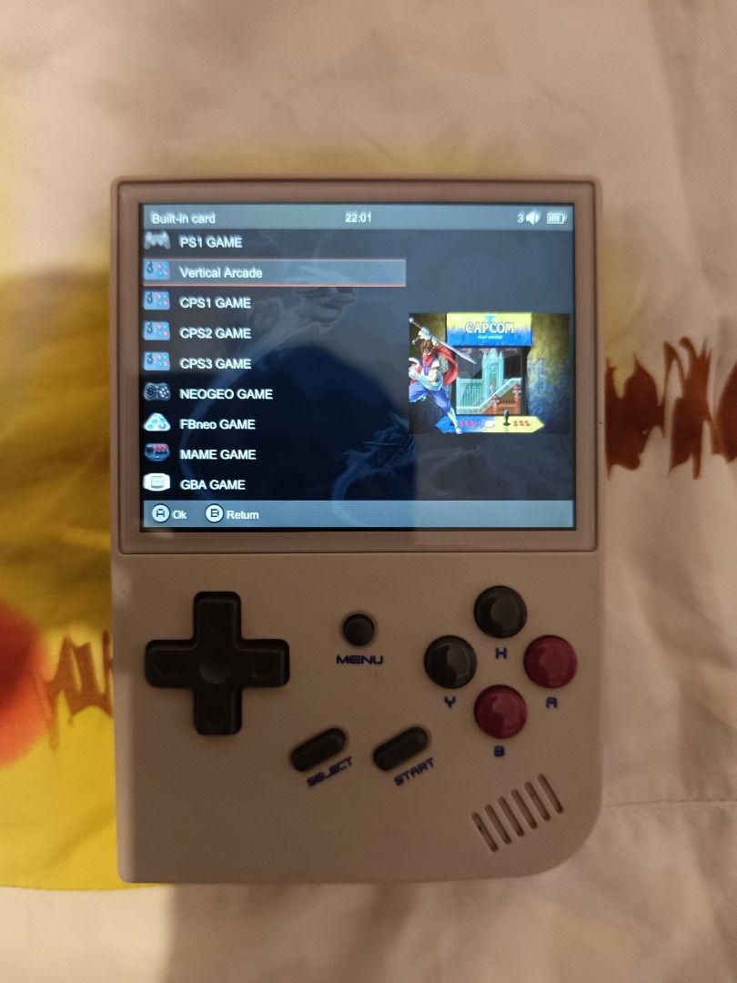Anbernic RG35XX Handheld Game Console (Category: Nintendo) located in Manila. Submitted by marketplace.88 (Listing ID 1469354288, Image 1). Description: - Model: Anbernic RG35XX retro handheld console - Color: Grey with classic purple and black buttons - Display: Clear 3.5-inch screen for great visuals - Compatibility: Plays tons of classic systems including PS1, Arcade, GBA, and NEOGEO - Features: Ergonomic shoulder triggers on the back for comf